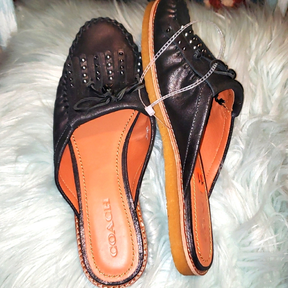 COACH leather slide loafers.